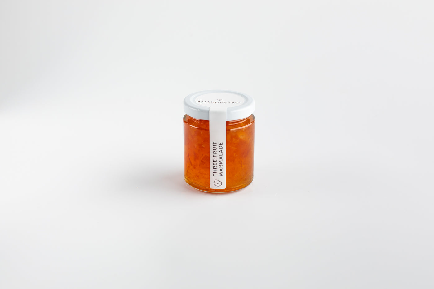 Jar of marmalade with a white lid on a light gray background