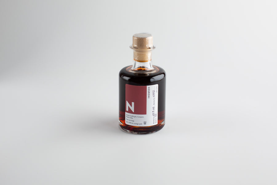 Bottle of alcohol with a label on a light gray background