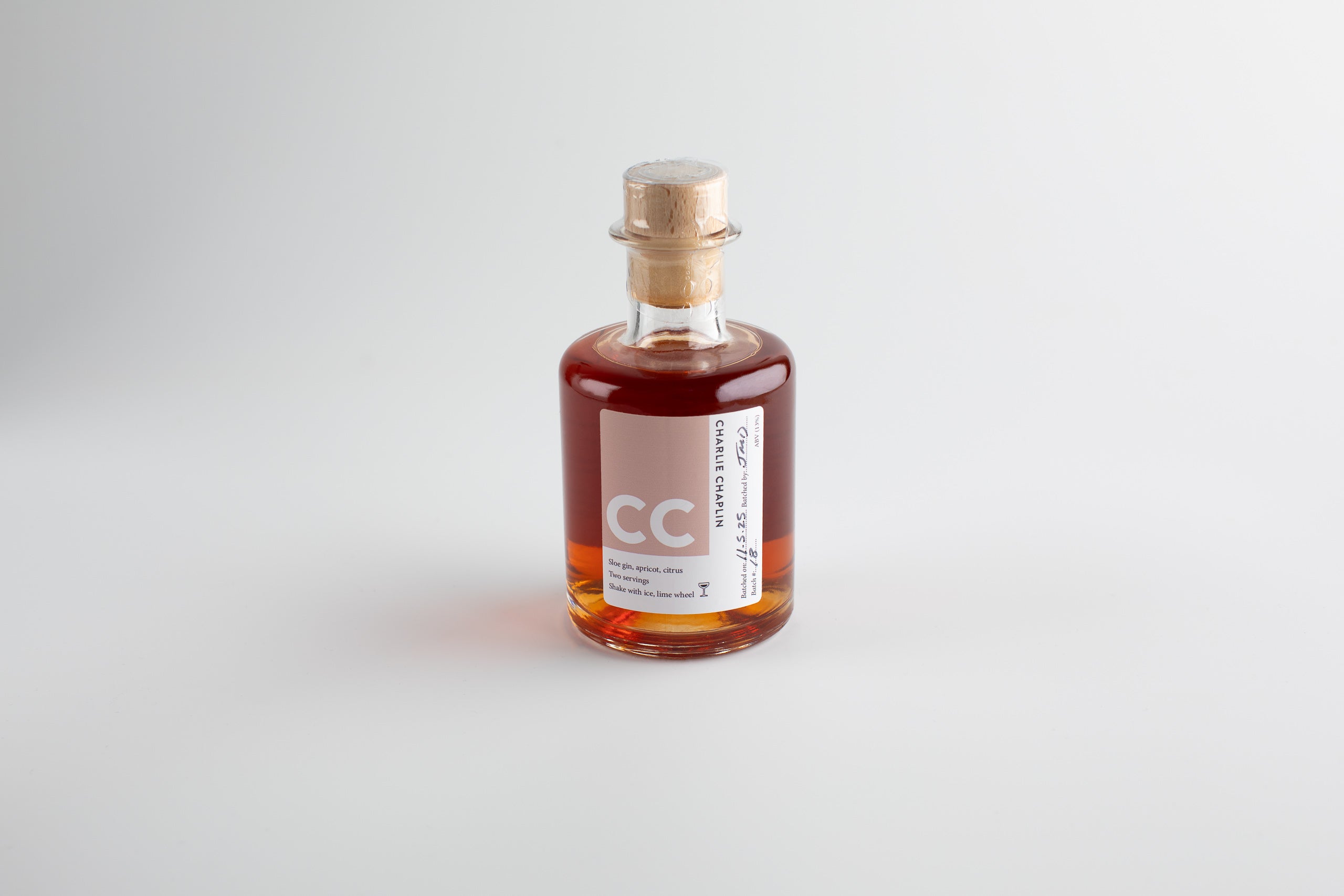 Small bottle with a cork lid on a light gray background