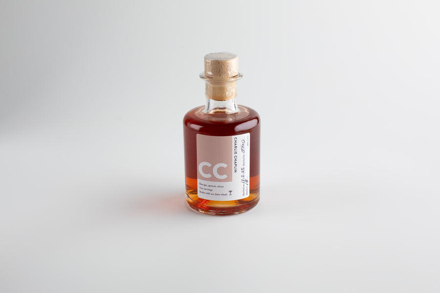 Small bottle with a cork lid on a light gray background