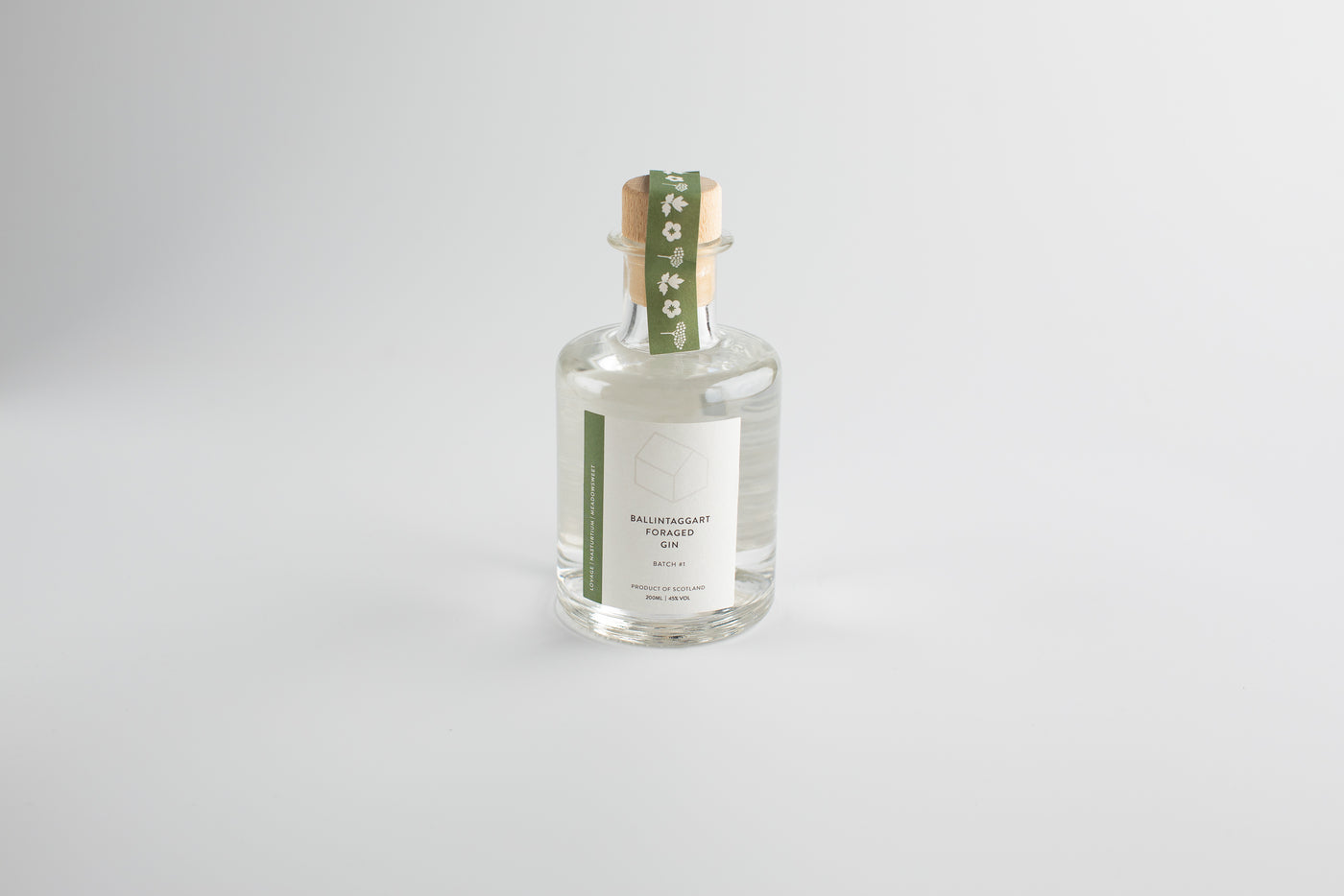 Clear bottle with a green label on a light gray background