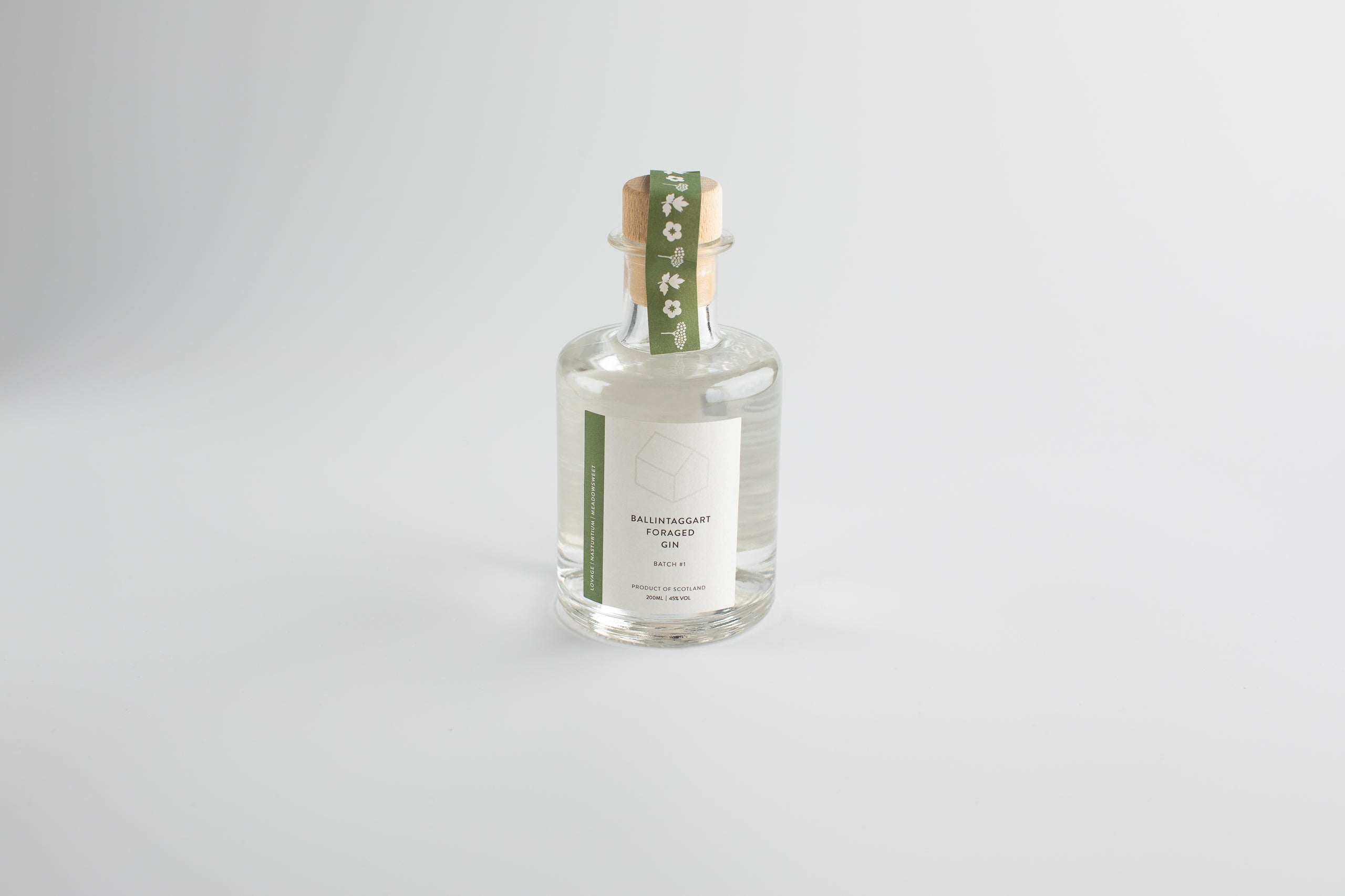 Clear bottle with a green label on a light gray background