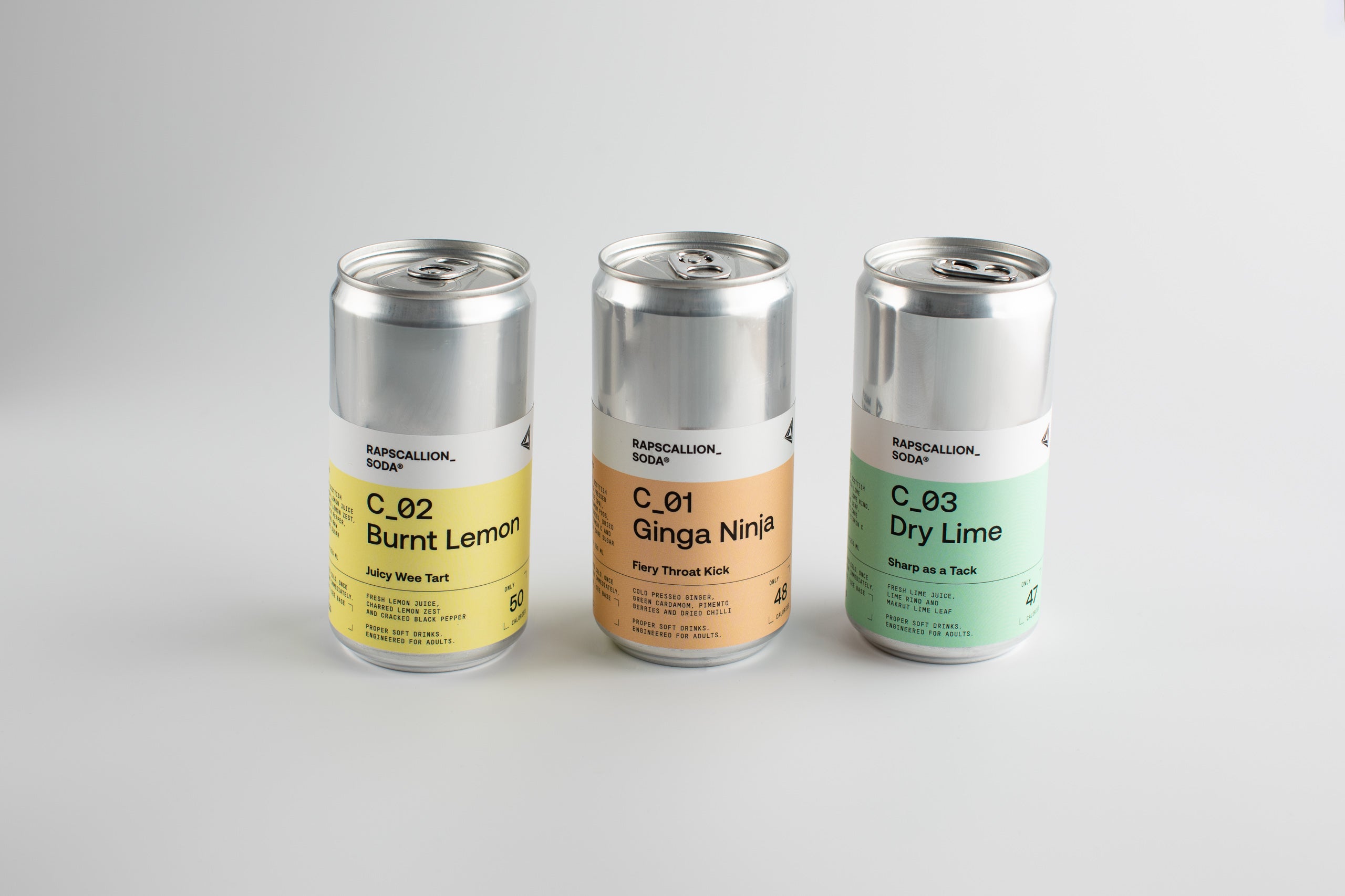 Three cans of a beverage brand on a light gray background