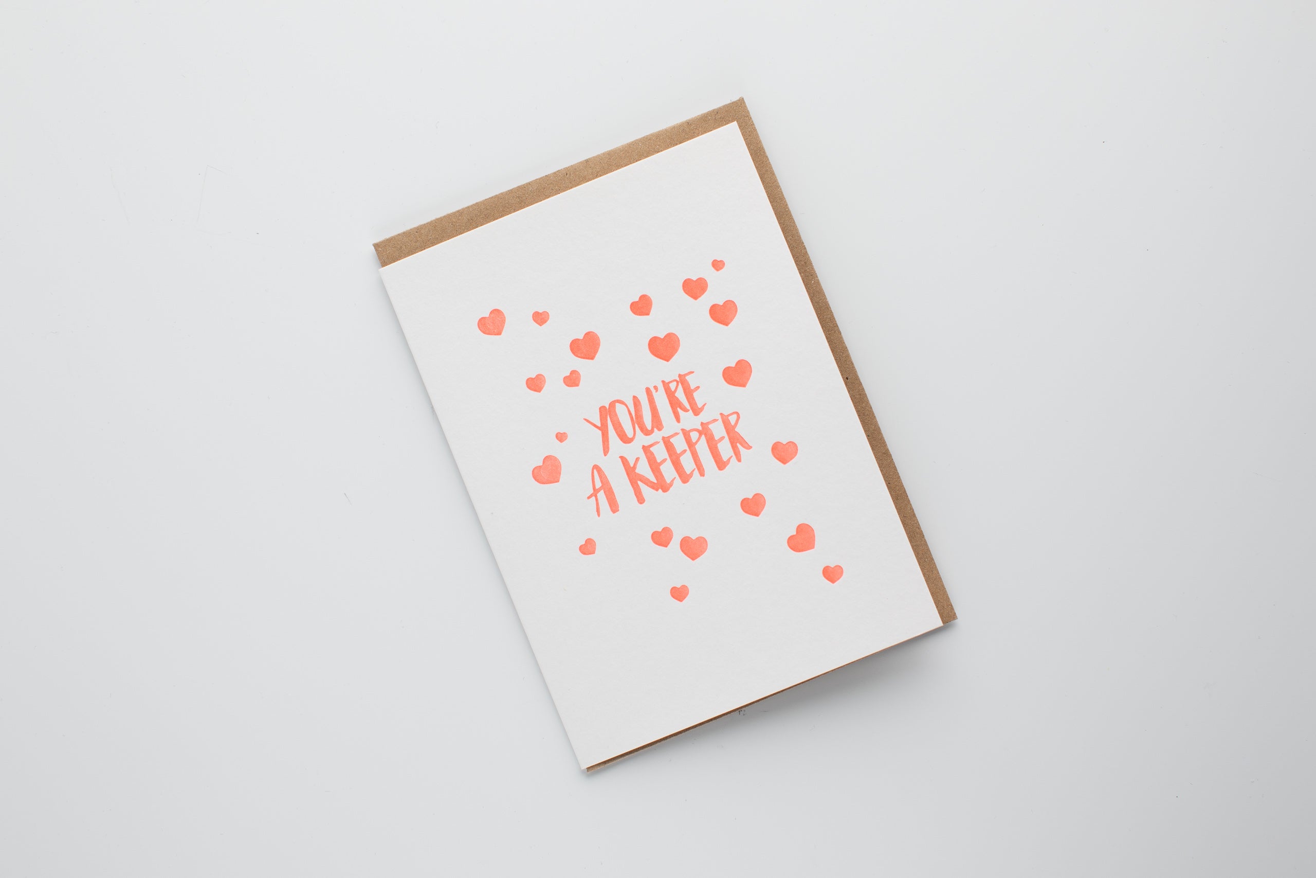 Greeting card with heart patterns and text on a white background