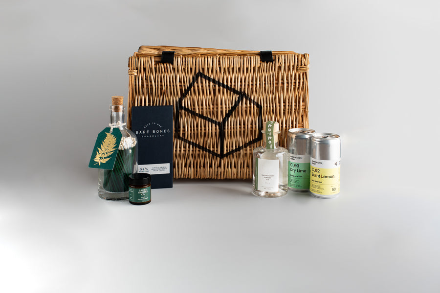 Wicker basket with decorative items on a gray background