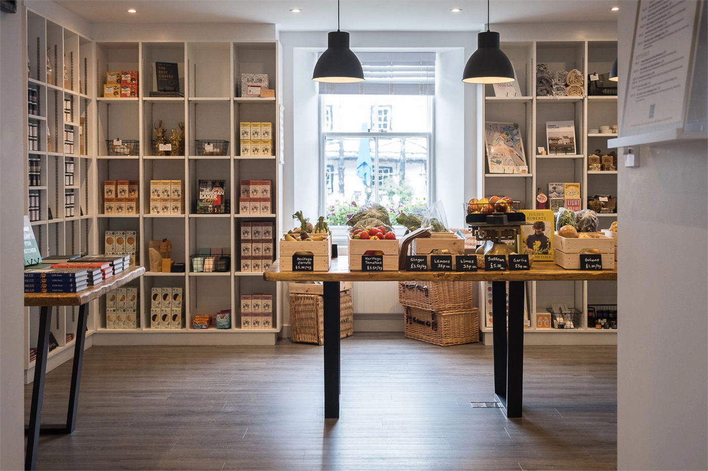 Store interior with shelves displaying products and a table with boxes of groceries.